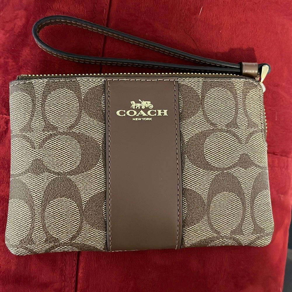 NWT Coach corner zip wristlet in signature canvas.